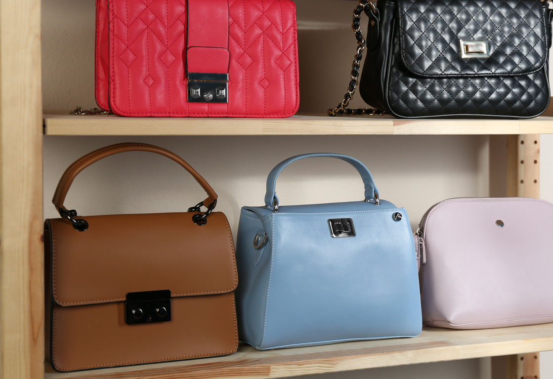 Collection of Stylish Leather Bags on Wooden Shelving Unit
